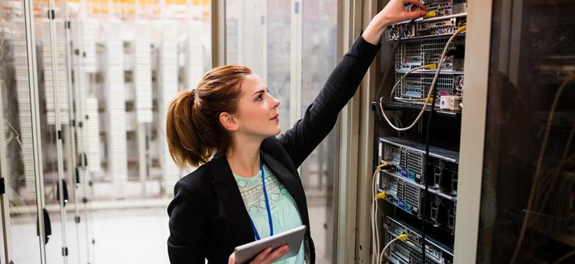 female technician preventing network failure in data center